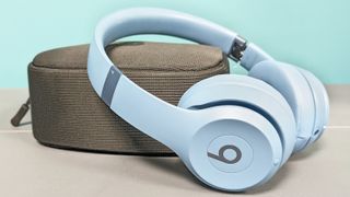 Beats Solo 4 wireless headphones resting on case